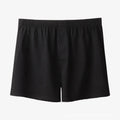 Men's solid colour cotton boxer shorts on a hanger, showing loose fit and high waist.