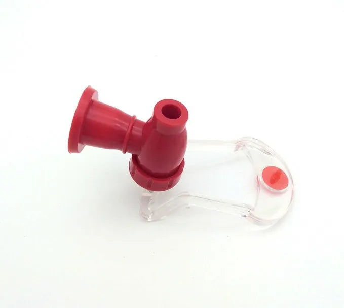 Red plastic Magic Tap soda dispenser attached to 2-liter bottle showing push-in tap mechanism