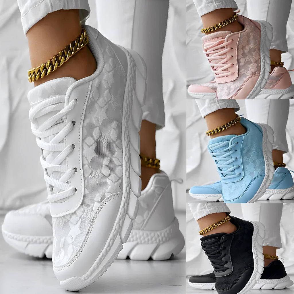 Women's white canvas casual running shoes with flat sole on a light background.