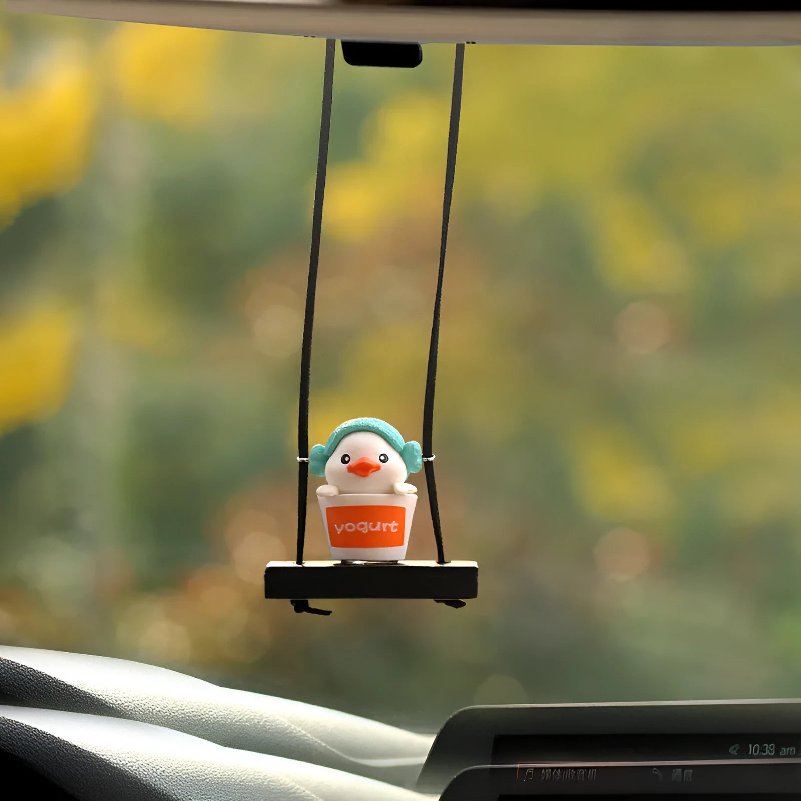 Yellow plastic duck car hanging ornament in cartoon style, shown in four design variants.