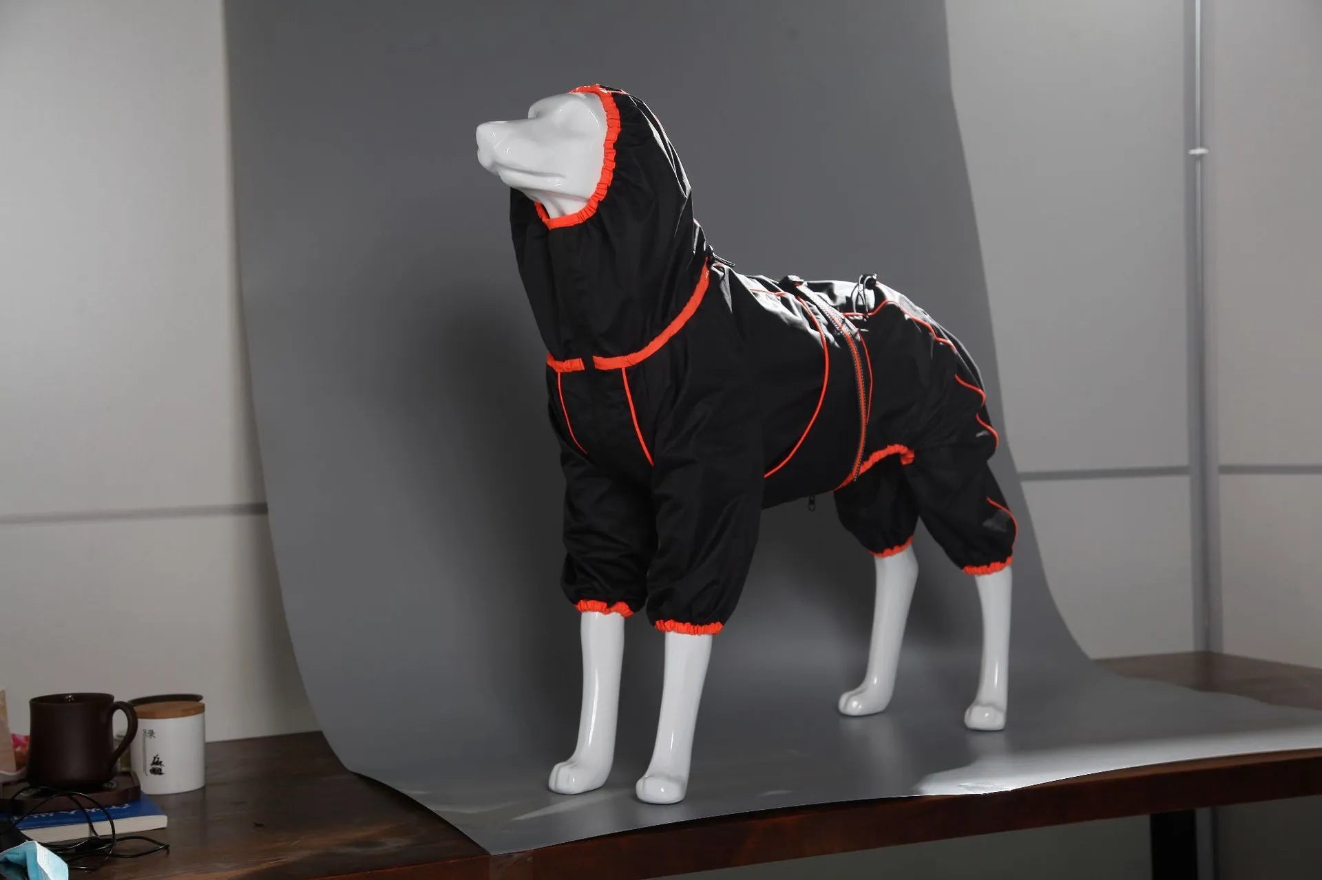 Red polyester padded dog jacket with zip front on a medium-sized dog.
