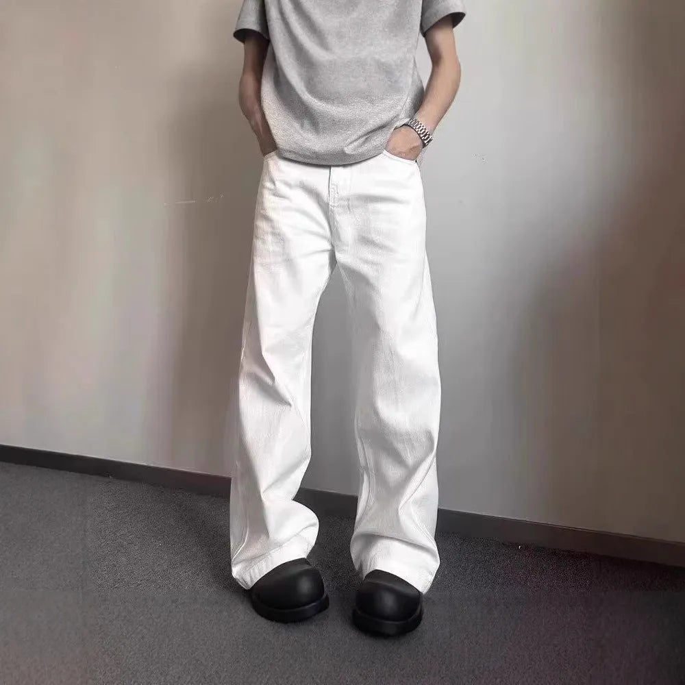Men's white loose straight-leg wide-leg denim jeans on a mid-waist with a zipper fly.