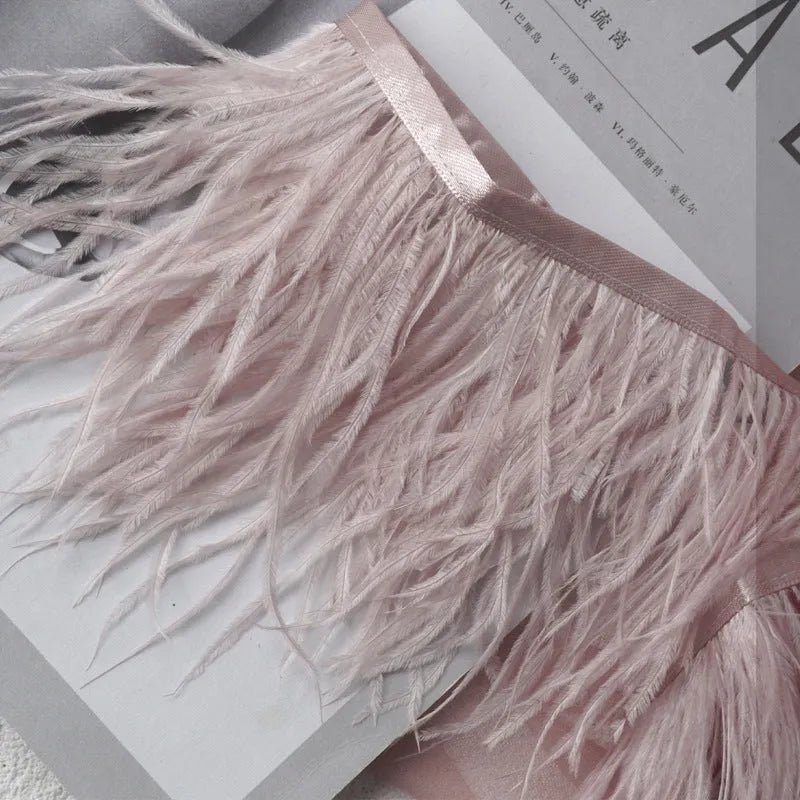Decorative feather cloth strip in multiple colours including white, black, and mint green for DIY clothing and craft projects