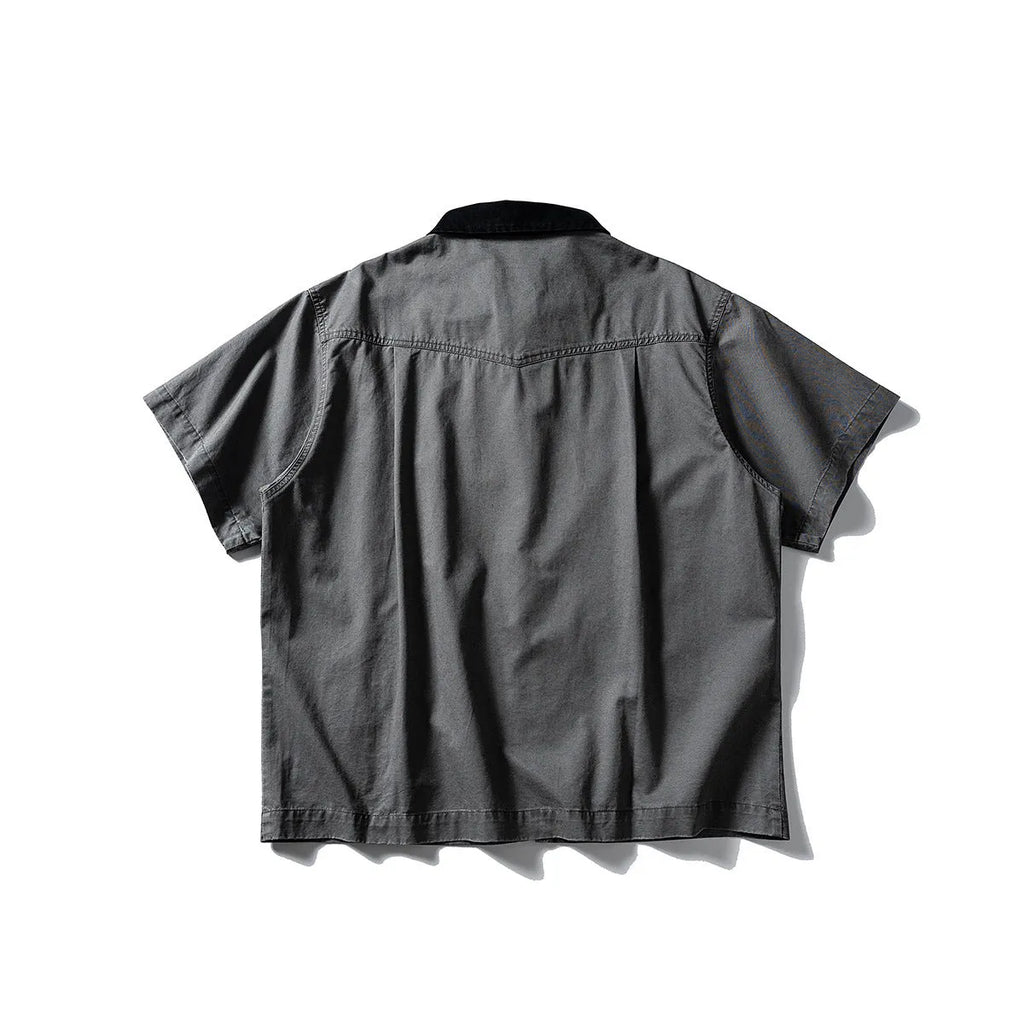 Grey washed cotton short sleeve overall shirt on a hanger, loose fit.