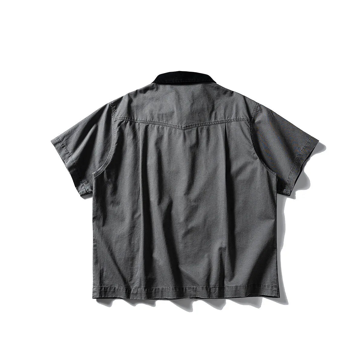 Grey washed cotton short sleeve overall shirt on a hanger, loose fit.