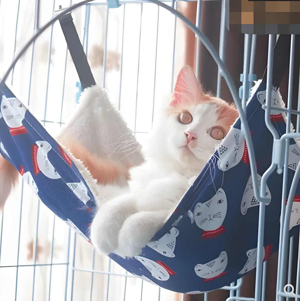 Double-sided lambskin cat hammock nest hanging in a cat cage with beige cat print pattern