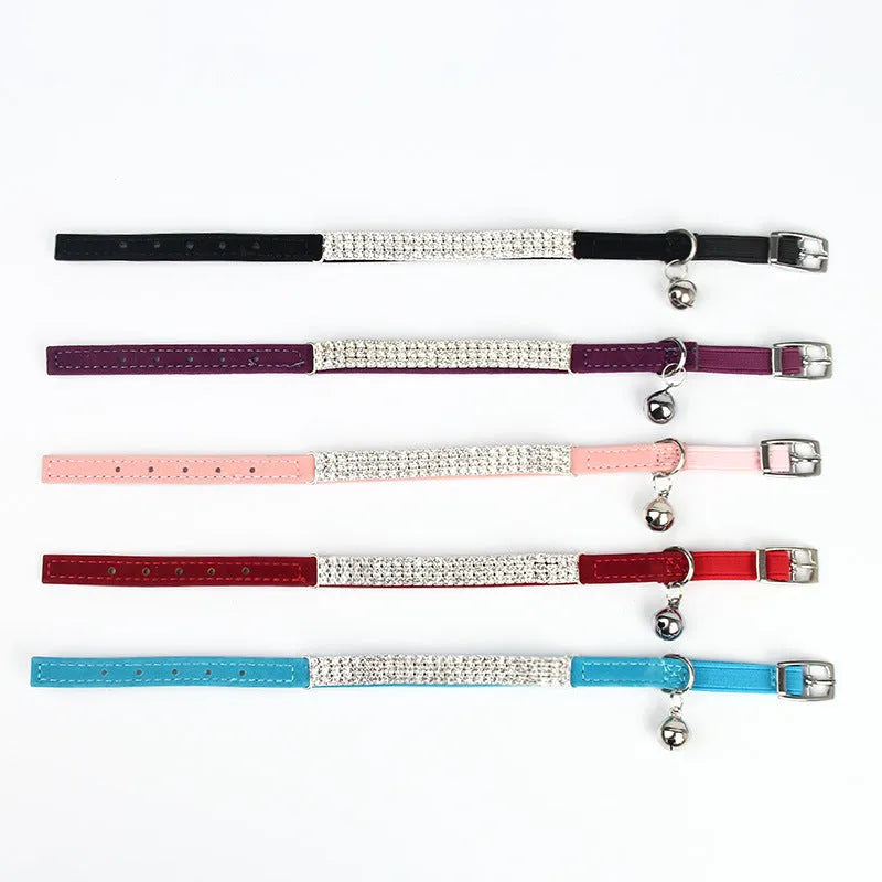 Red velvet cat collar with rhinestone detail, adjustable from 20cm to 30cm in length.