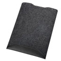 Minimalist black fabric laptop sleeve with built-in mouse pad on a flat surface