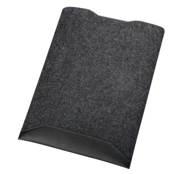 Minimalist black fabric laptop sleeve with built-in mouse pad on a flat surface