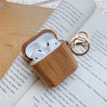 Wood grain clamshell earphone cover for AirPods 1 or 2 in carbonized wood colour, made from wood or bamboo.