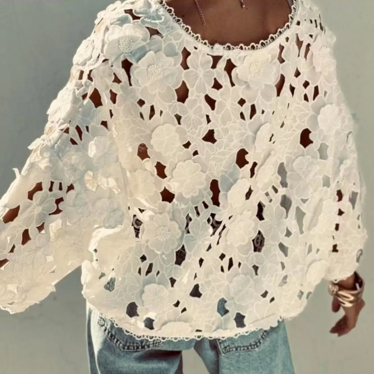 Black loose fit lace cardigan with V-neck and 3D floral decoration on a hanger
