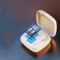 Pair of black semi-in-ear wireless Bluetooth earphones showing battery display.