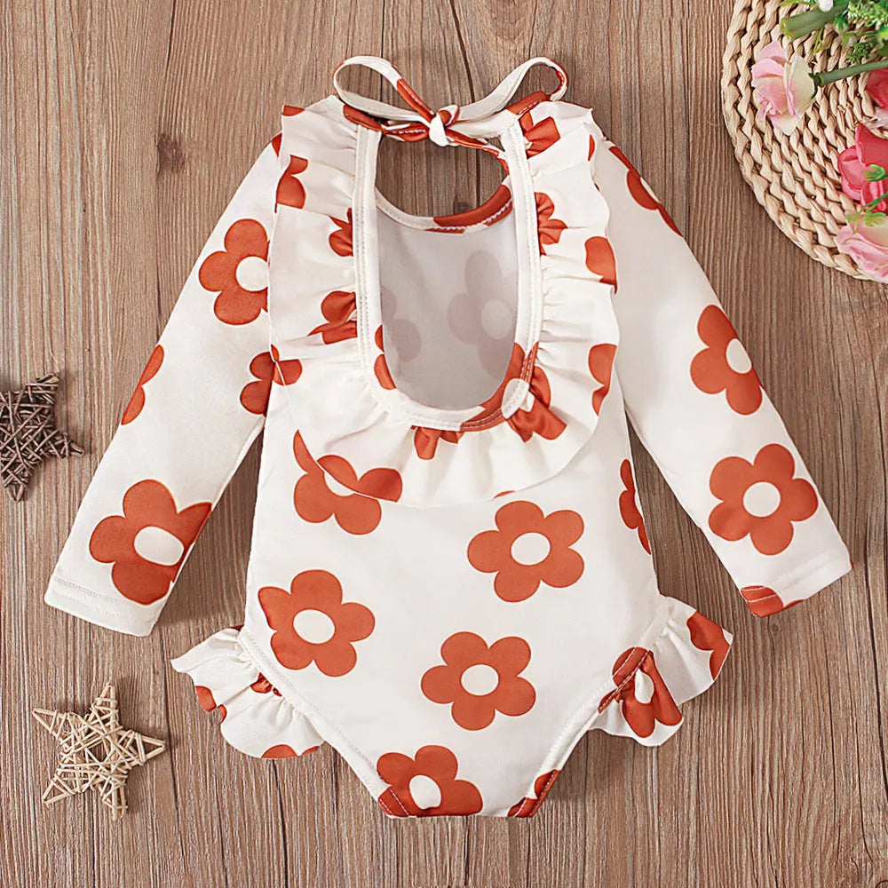 Girls floral print swimsuit with crew neck front and open back in orange colour