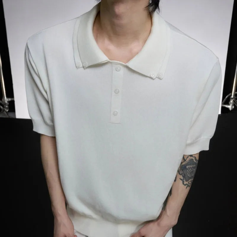 Black loose fit men's short sleeve shirt with a lapel collar and fastener decoration.