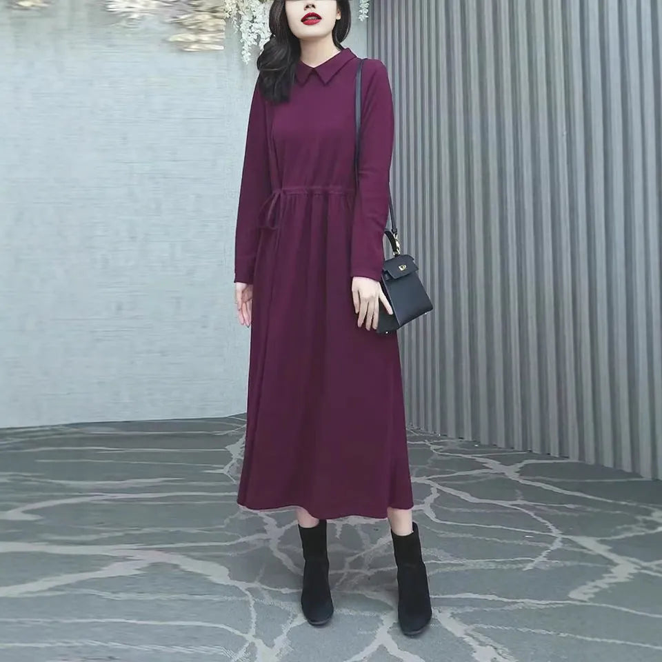 Purplish red women's long sleeve knee-length dress on a hanger, urban commute style.