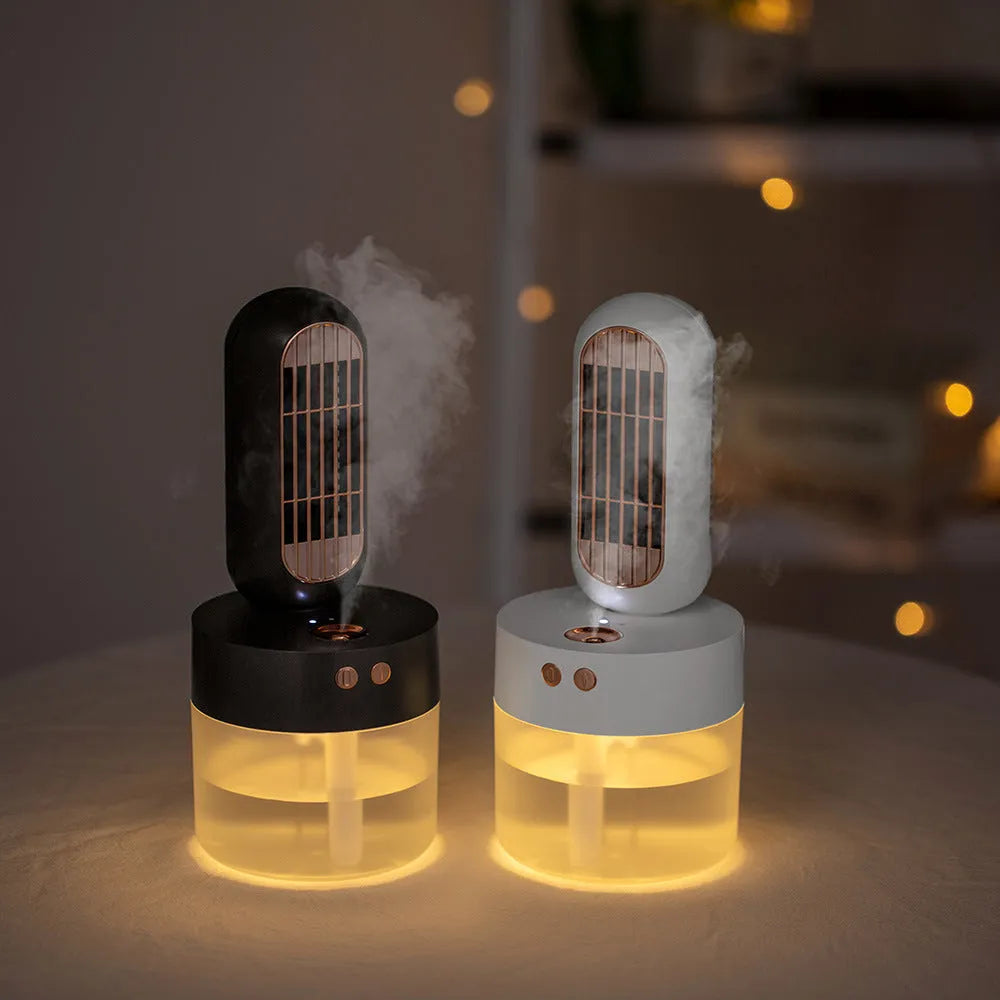 Small black and white personal humidifier fan with oscillating head on a desk