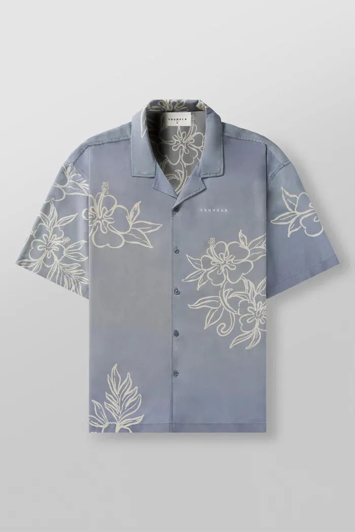 Man's loose-fitting printed short sleeve top in a light colour, showing cardigan style and floral pattern detail.