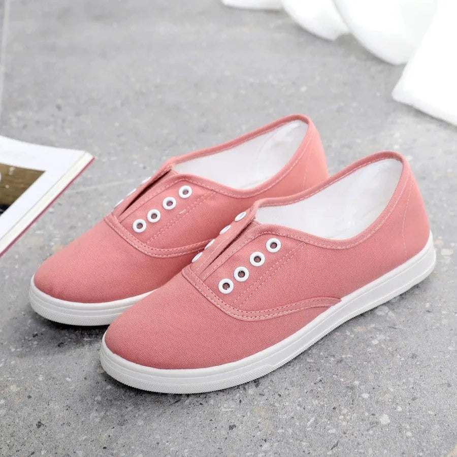 Low-top canvas casual shoes in black, grey, pink, and white colours with flat plastic soles