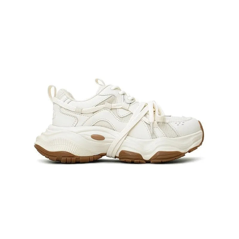 Women's beige platform running sneakers with round toe and lace-up design on white background