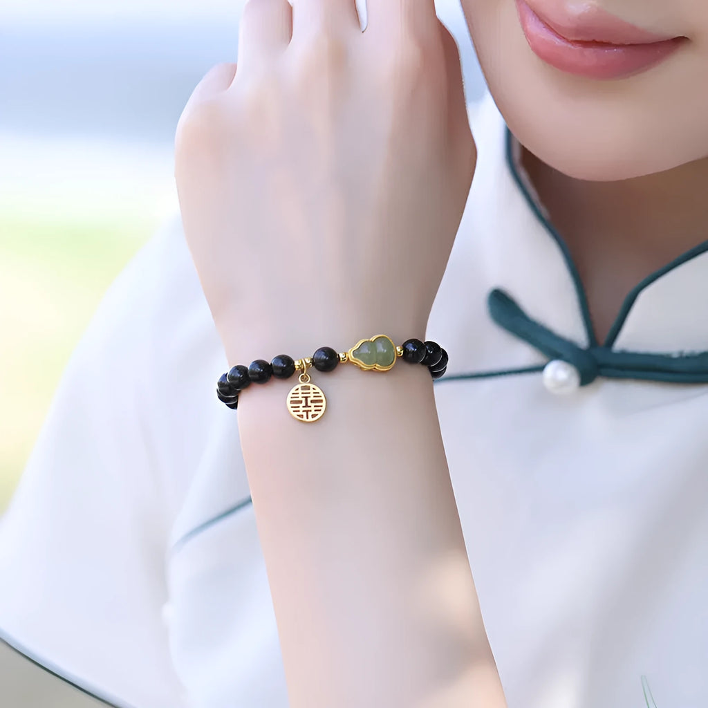 Black obsidian bracelet with a Hetian jade gourd charm, showing geometric beads in 6mm, 8mm, and 10mm size options.