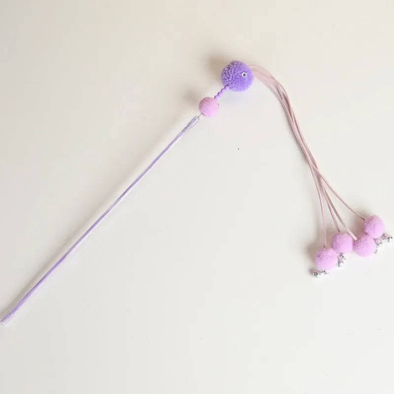 Colourful cat toy stick with a feather tassel on a foam handle in blue, pink, and purple options.
