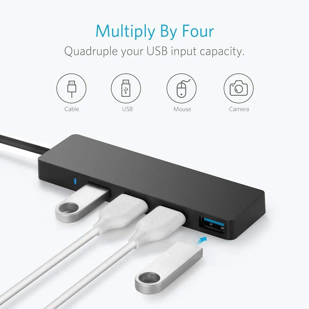 Black USB 3.0 hub with 4 Type-A ports and a 30cm connected cable on a desk.