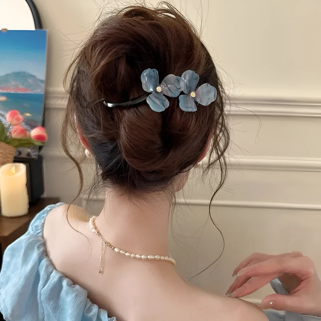 Close-up of a retro-style floral bobby pin hair clip with acrylic petals in a choice of colours.