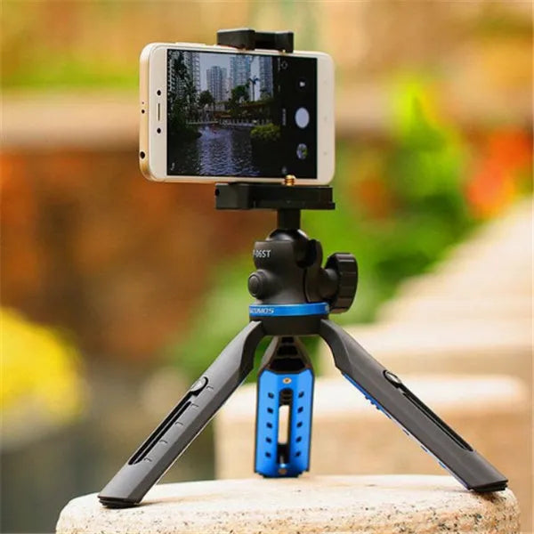Black plastic and aluminium desktop tripod stand holding a mobile phone.