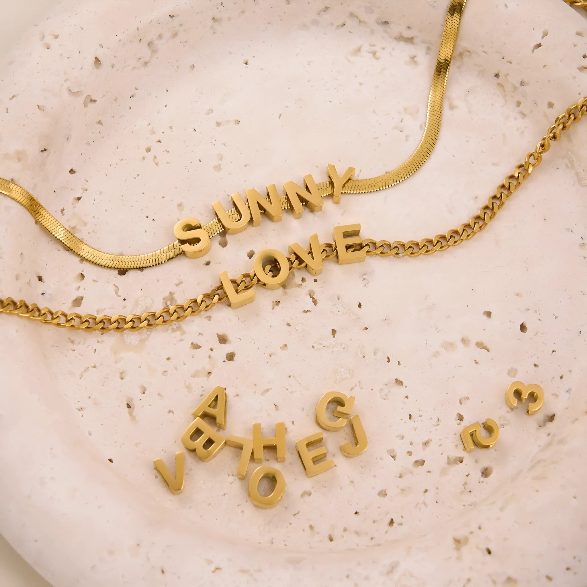 Titanium steel necklace with a personalised letter charm on a 40.5cm gold electroplated chain.