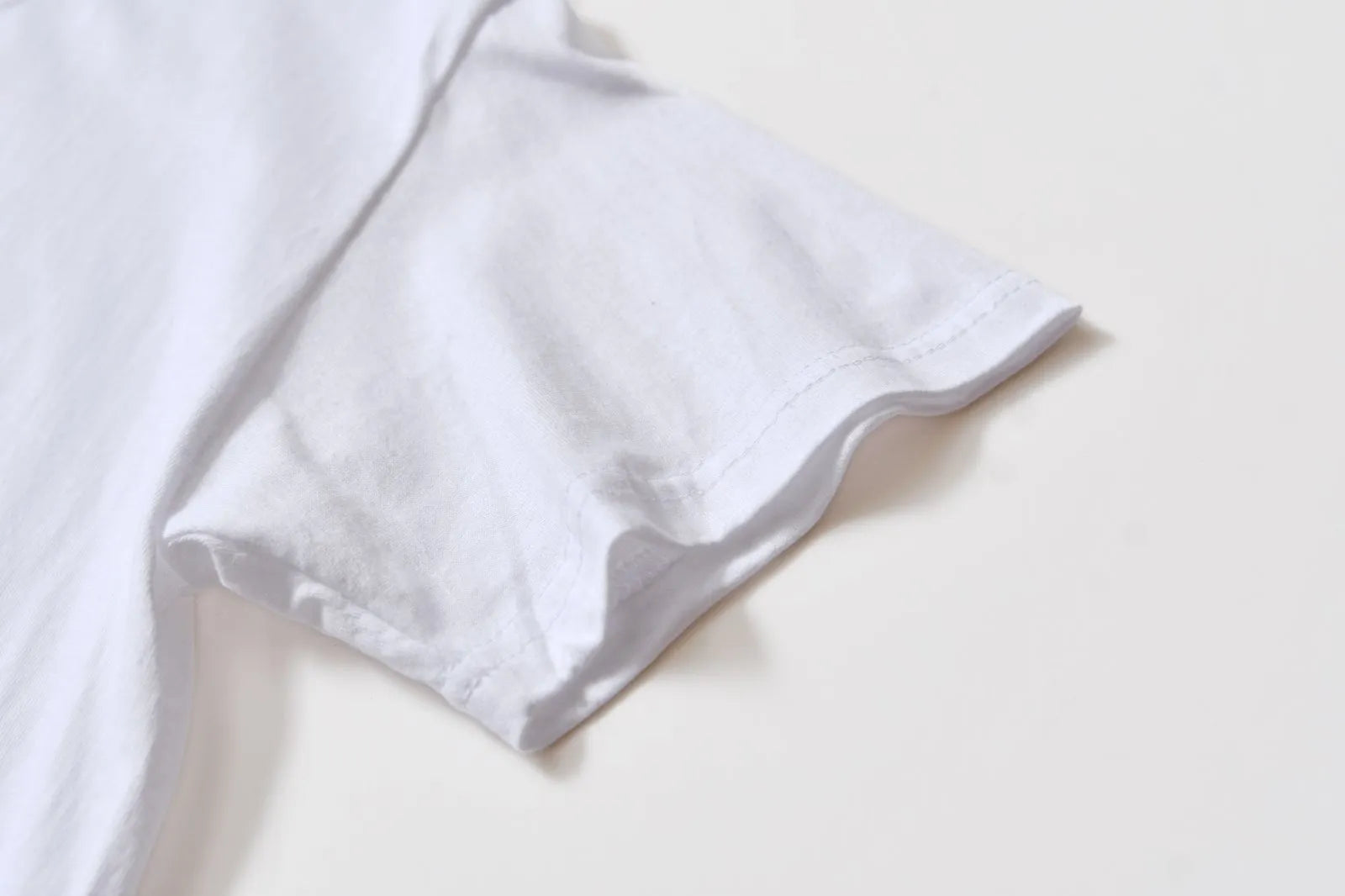 White cotton t-shirt overalls with short sleeves and a loose pullover fit