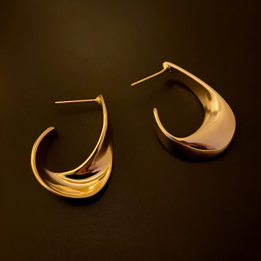 Twisted geometric metal earrings with circular design in gold or silver electroplated finish