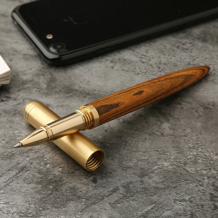 Brass and solid wood signature pen showing wood grain and metallic details.