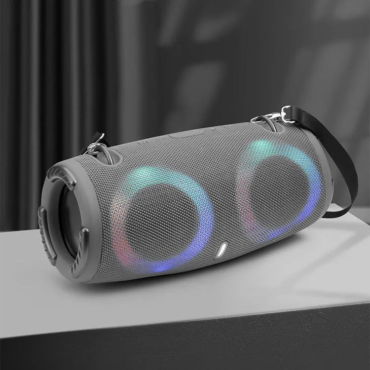 War Drum portable Bluetooth speaker in camouflage colour with dynamic RGB lights, showing carrying strap and control buttons.
