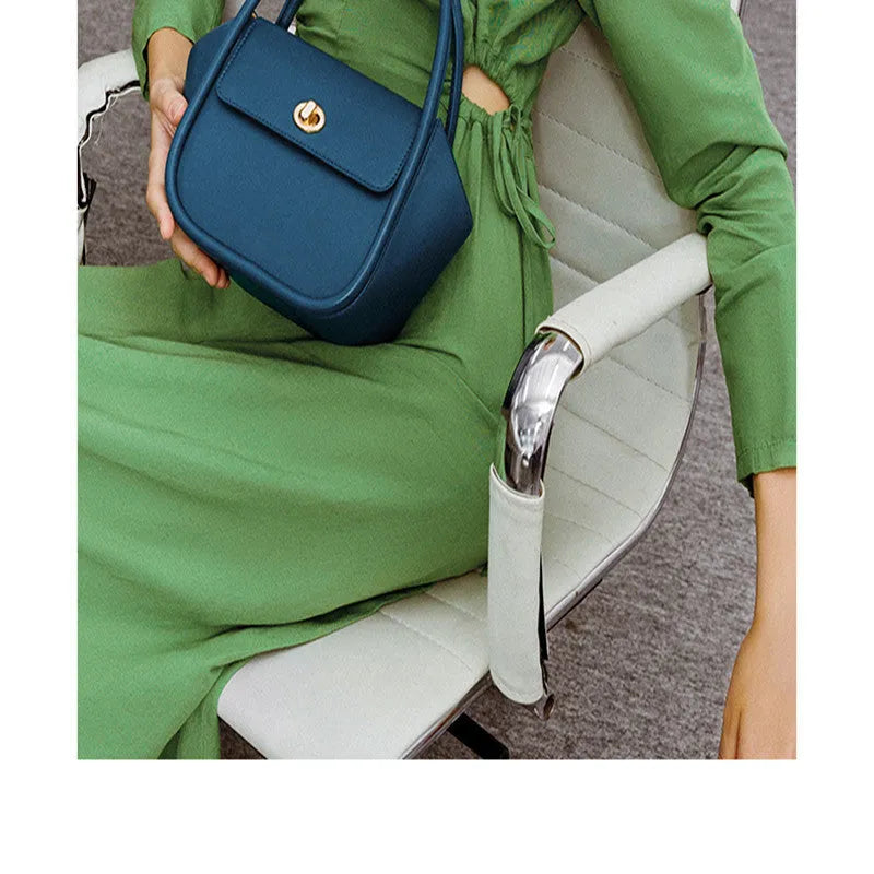 Winged shape leather tote handbag with a buckle and cross-body strap in cow leather