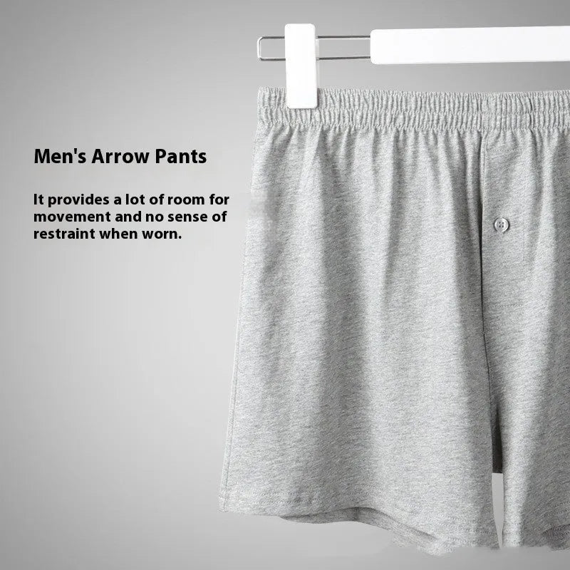 Men's solid colour cotton boxer shorts on a hanger, showing loose fit and high waist.