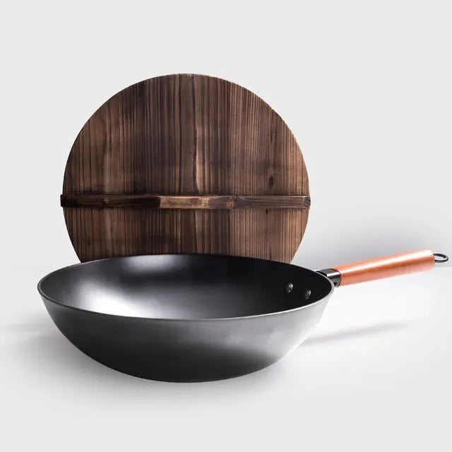 Black handmade iron wok with wooden handle, 32cm diameter.
