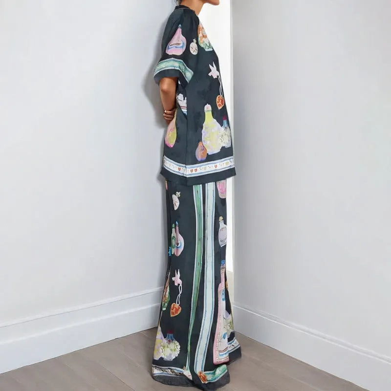 Black women's cardigan and trouser set with cartoon animation print.