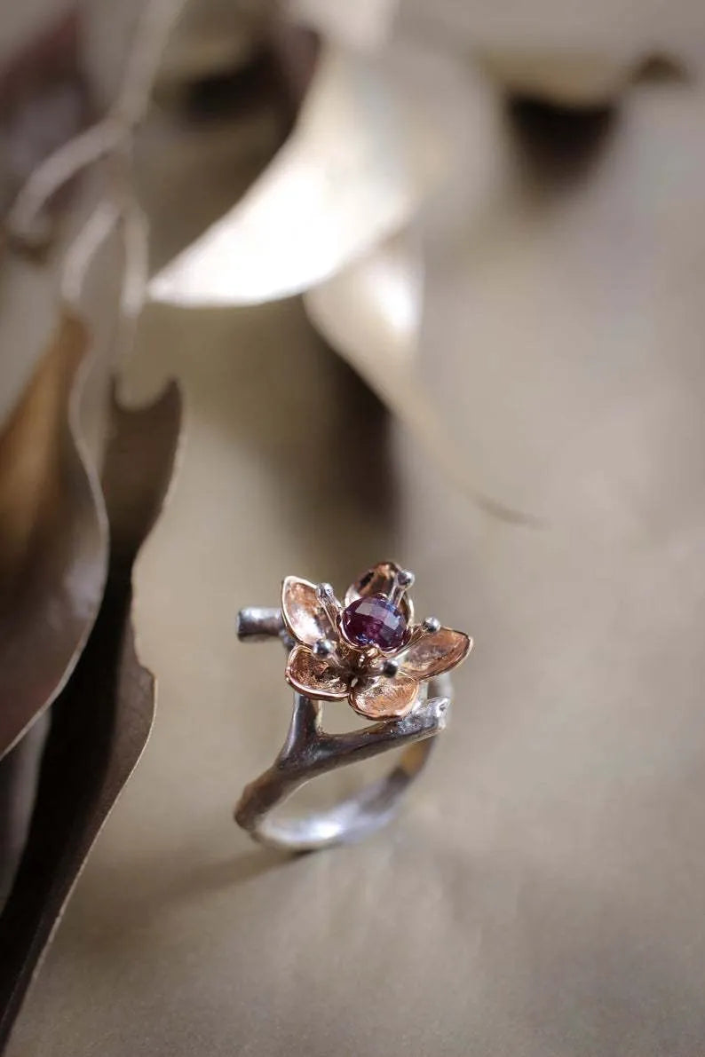 Silver two-tone floral geometric alloy ring for women on a plain background.