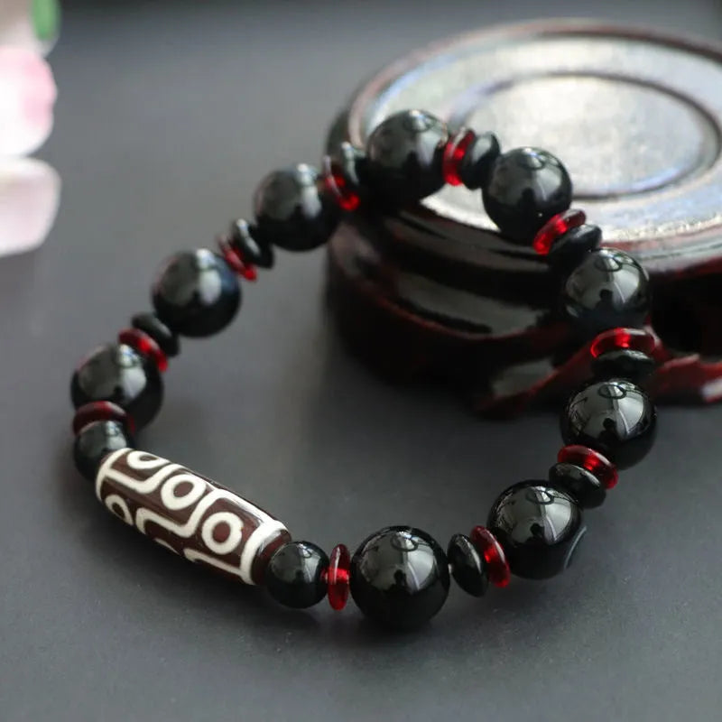 Black agate Dzi bead bracelet with hand-woven construction and 11mm geometric beads