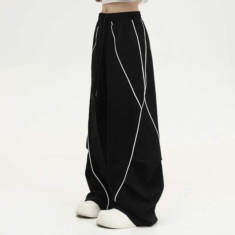 Black pleated wide-leg hip hop sports trousers with striped pattern and elasticated waist.