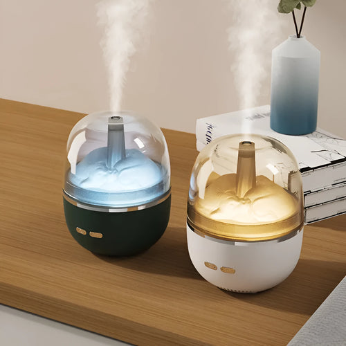 Green ultrasonic aromatherapy humidifier with heavy fog and colourful gradient light on a desk