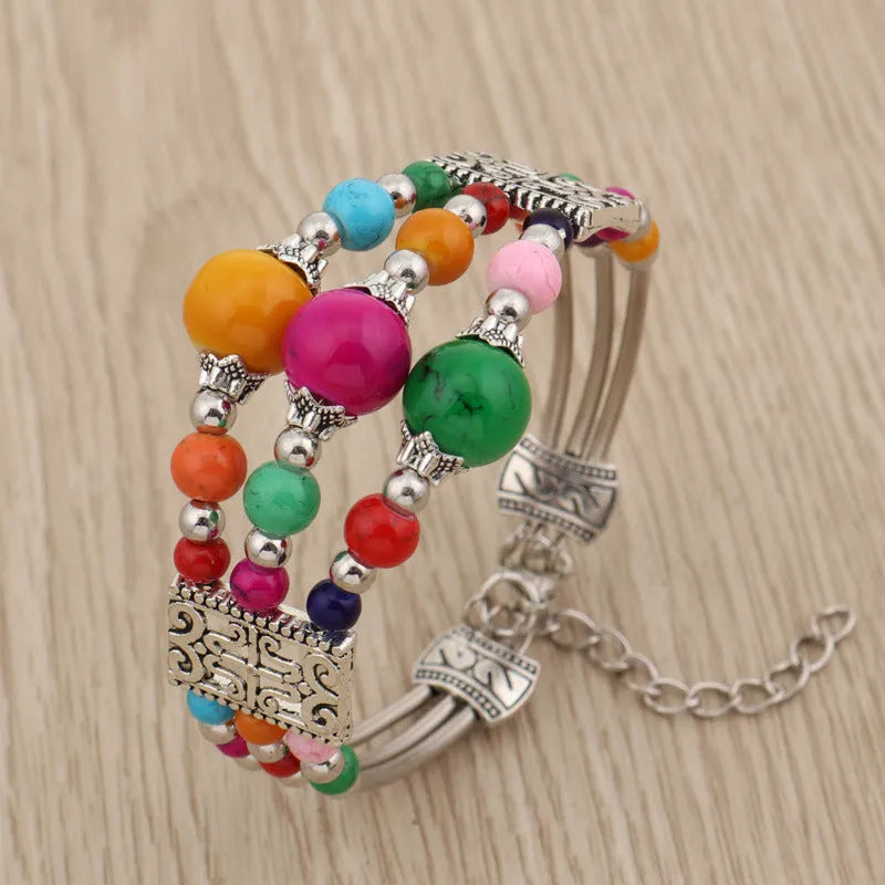 Tibetan style wide bangle bracelet with colourful beads, turquoise tone, tassel detail and electroplated alloy finish