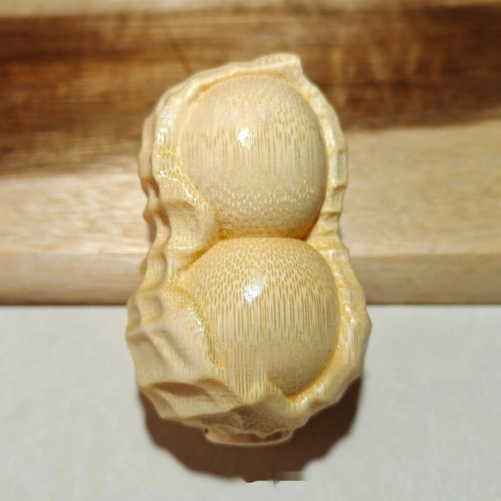 Solid bamboo carving peanut ornament on natural background