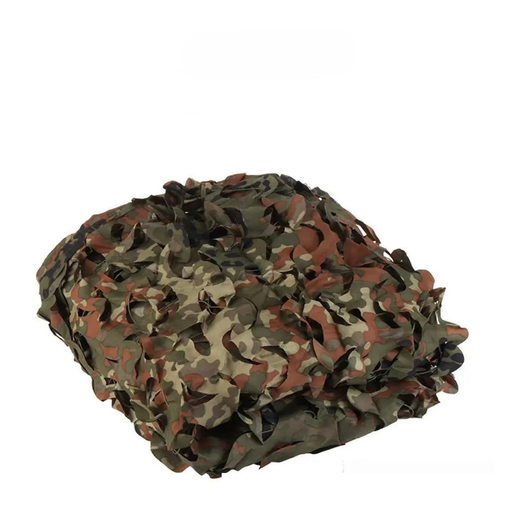 Green camouflage netting cover shown in a desert camouflage pattern, laid over outdoor terrain.