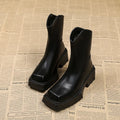 Black platform Martin boots for women with a square toe and back zipper on a rubber sole.