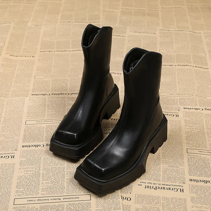 Black platform Martin boots for women with a square toe and back zipper on a rubber sole.