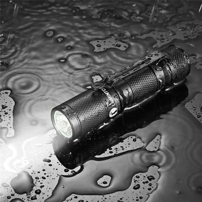 Black Lumintop Tool AA 2.0 aluminium keychain flashlight with magnetic tail cap on a keyring.