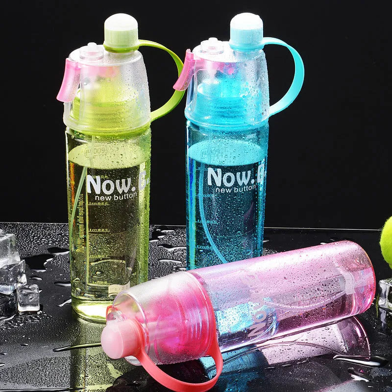 Green portable sports mist spray cup with transparent body, volume scale, handle, and spray mouth.