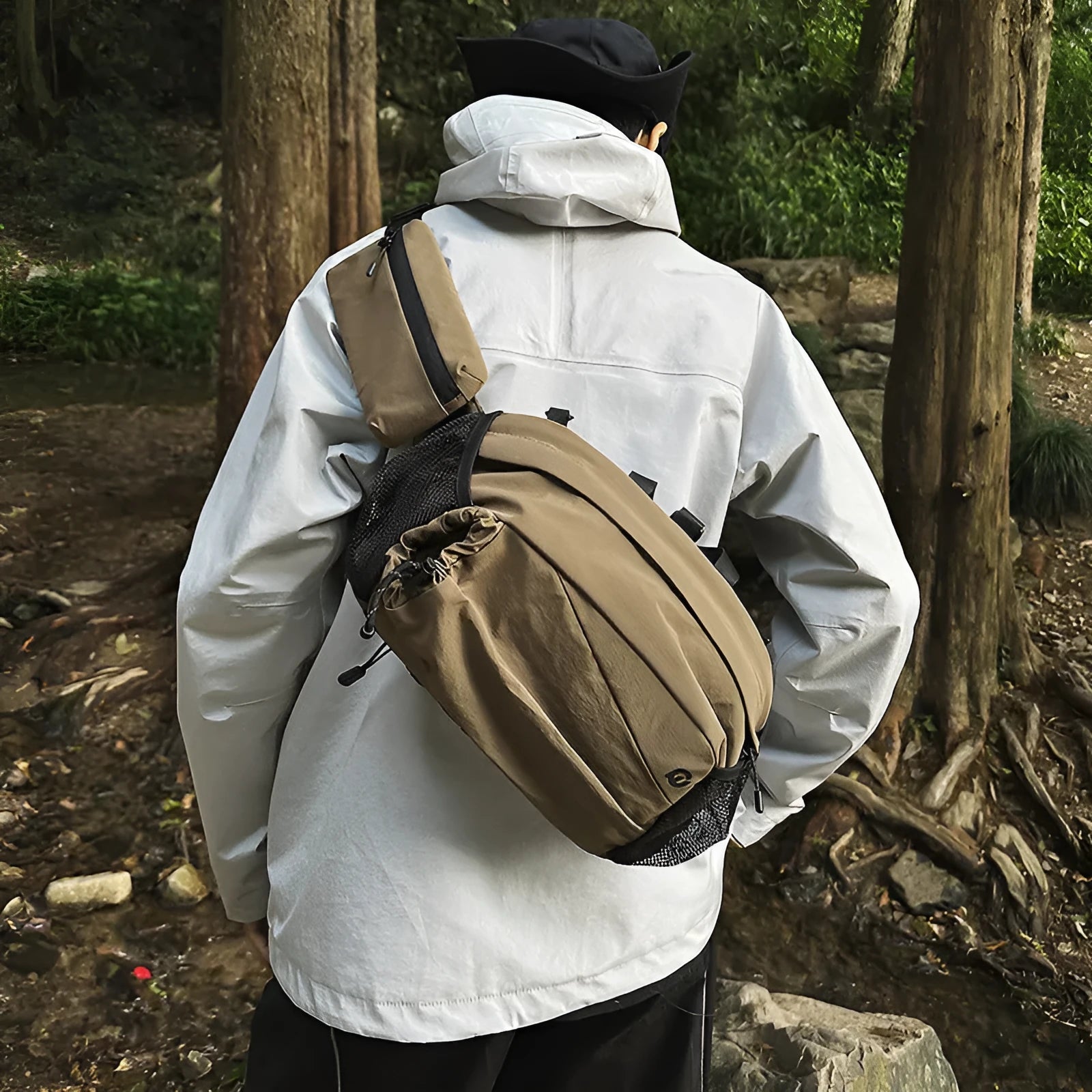 Unisex black nylon waist bag worn on the hip, also showing backpack straps.