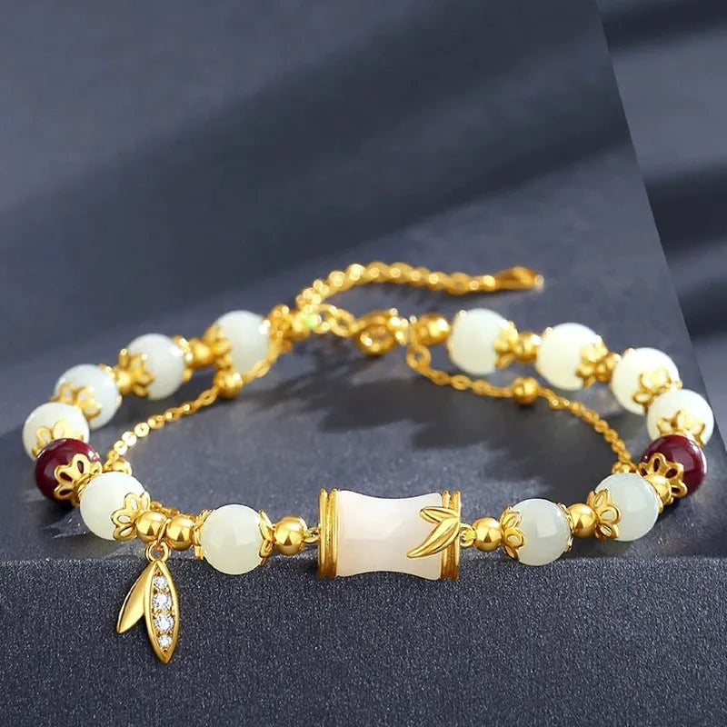 Bamboo-themed bracelet with a coloured glass flower and ruyi pattern in beige, green, light green, or white.